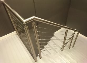 Modern fire stairs, view down from landing of handrail