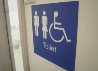 Unisex Accessible Disabled Toilet Sign with Braille and Tactile text, blue background